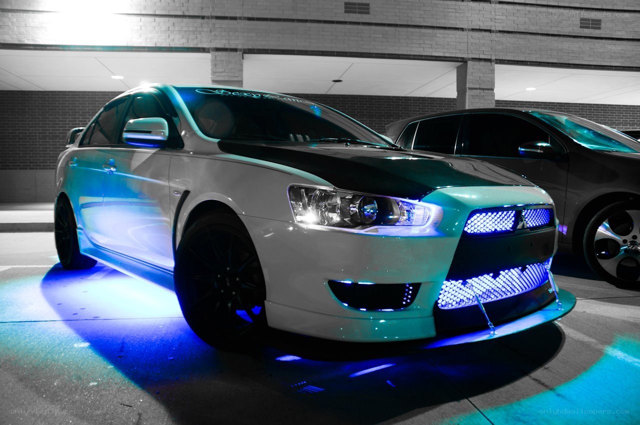 white mitsubishi with blue lights