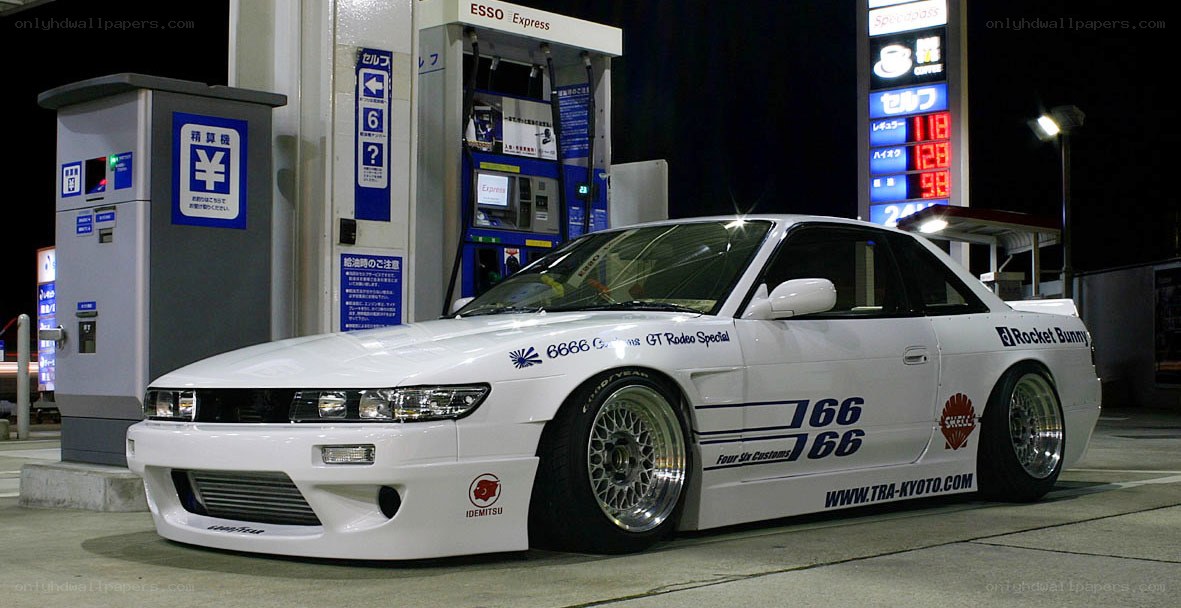 White modified car at gas station