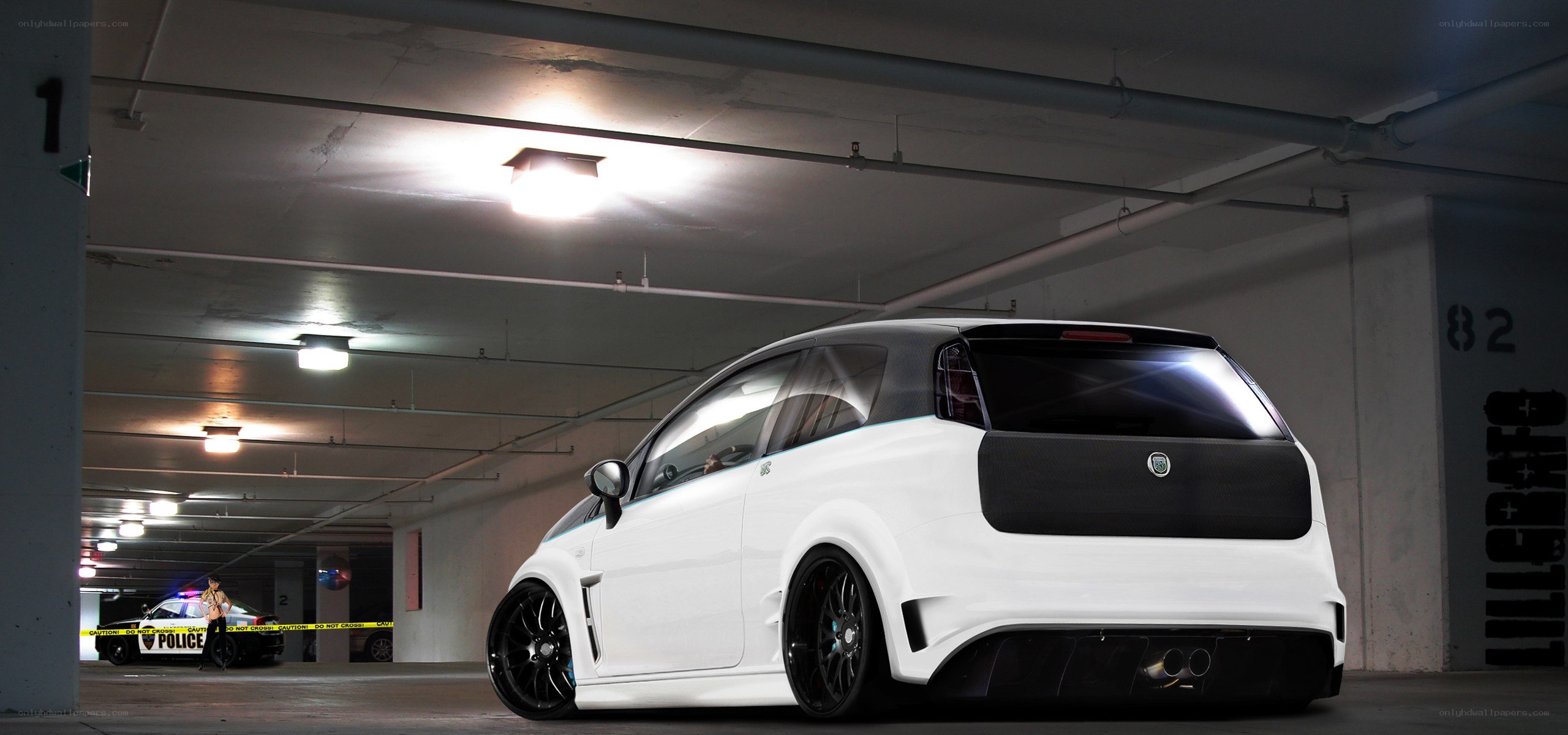 White modified car in parking garage