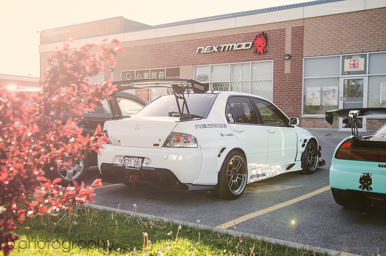 White modified car in parking lot