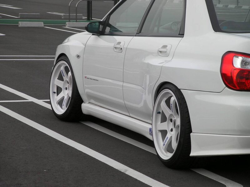 white modified car in parking lot