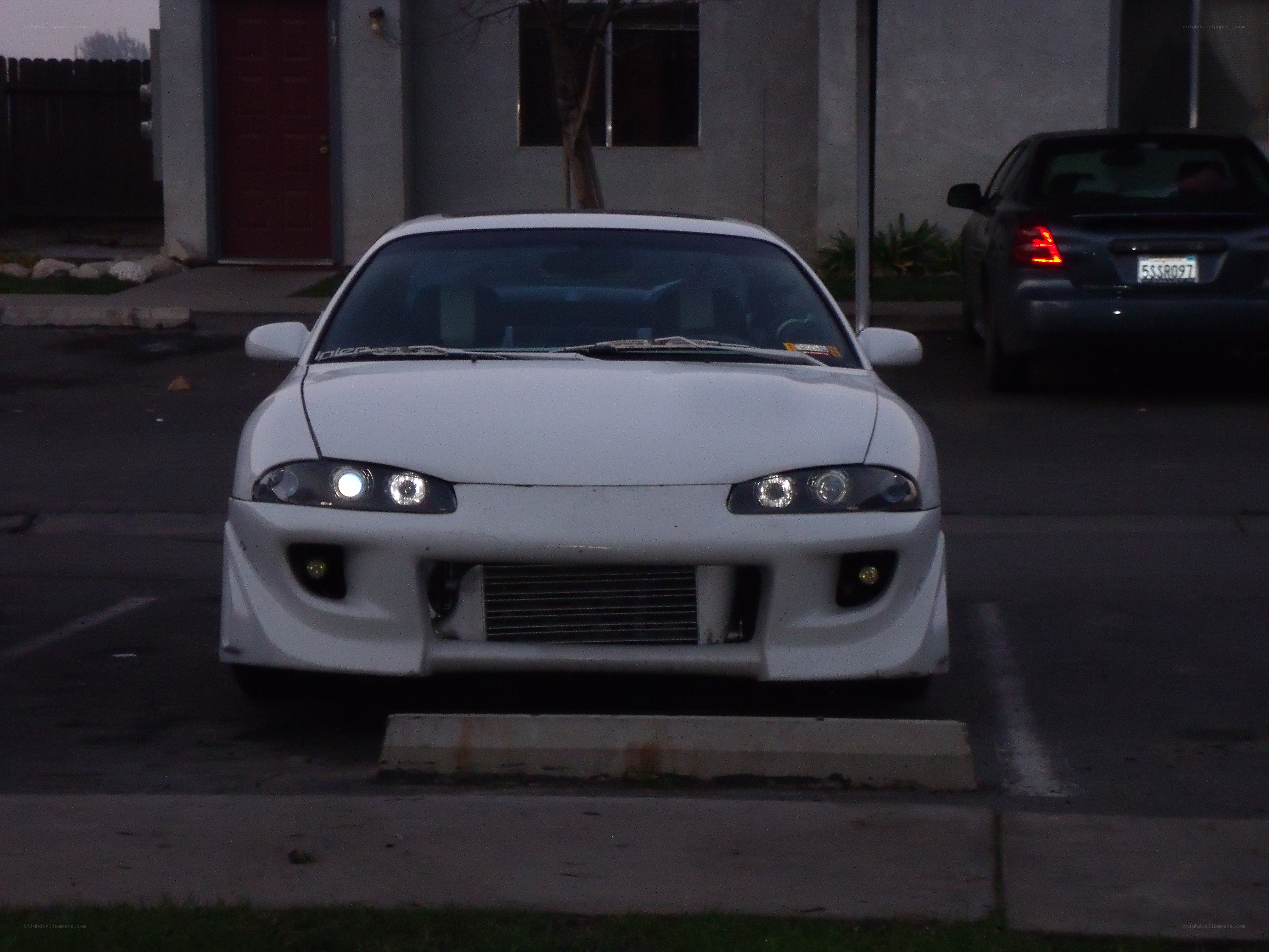 white modified car in parking lot