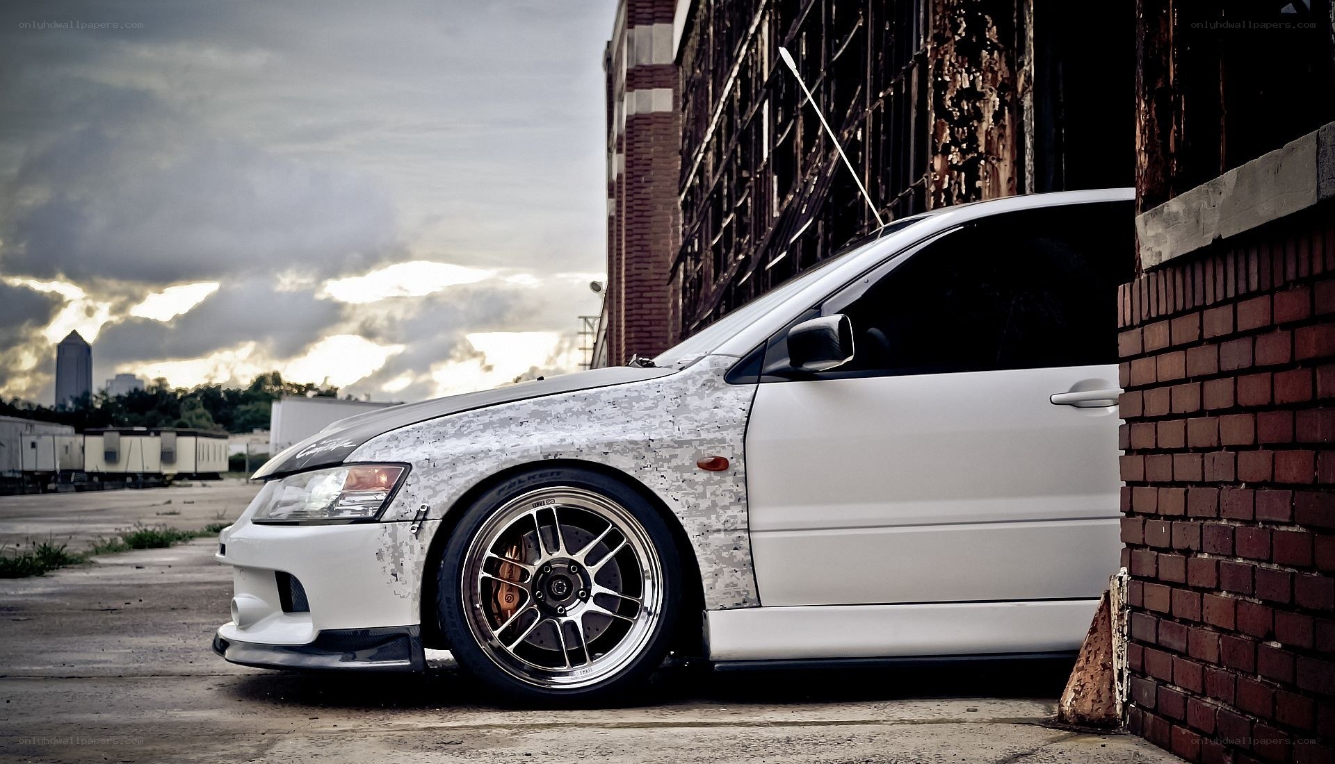 white modified car in urban setting