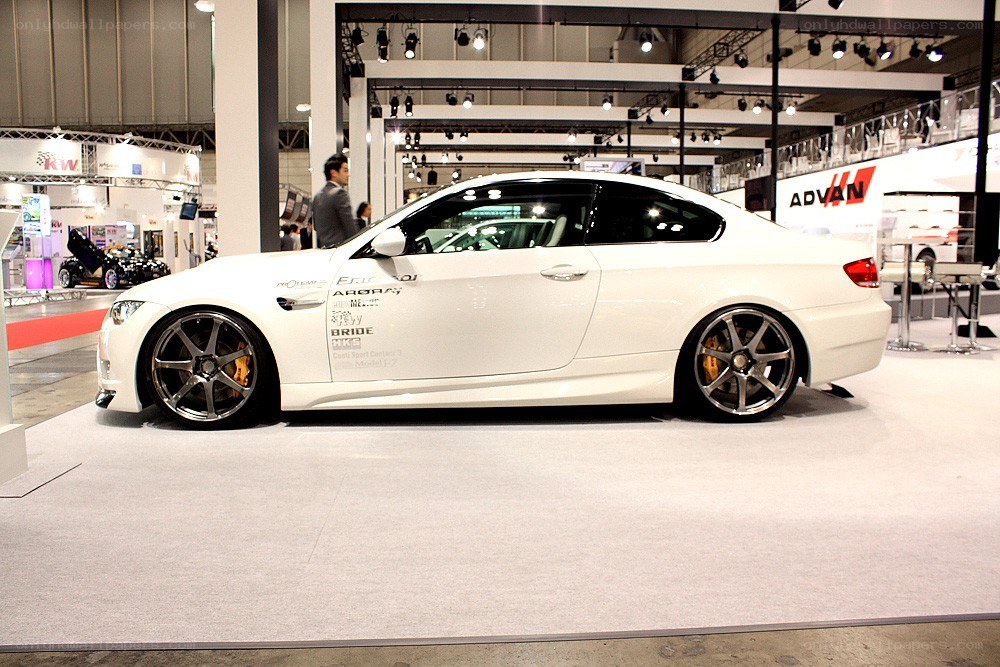 white modified coupe at auto show