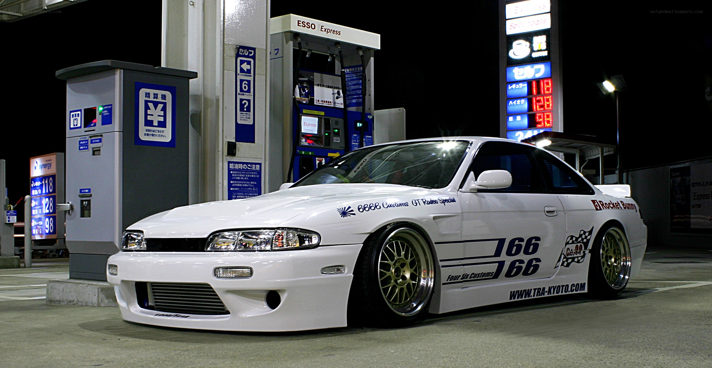 white modified coupe at gas station