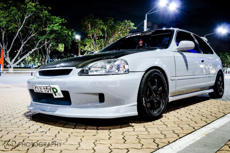 white modified hatchback at night