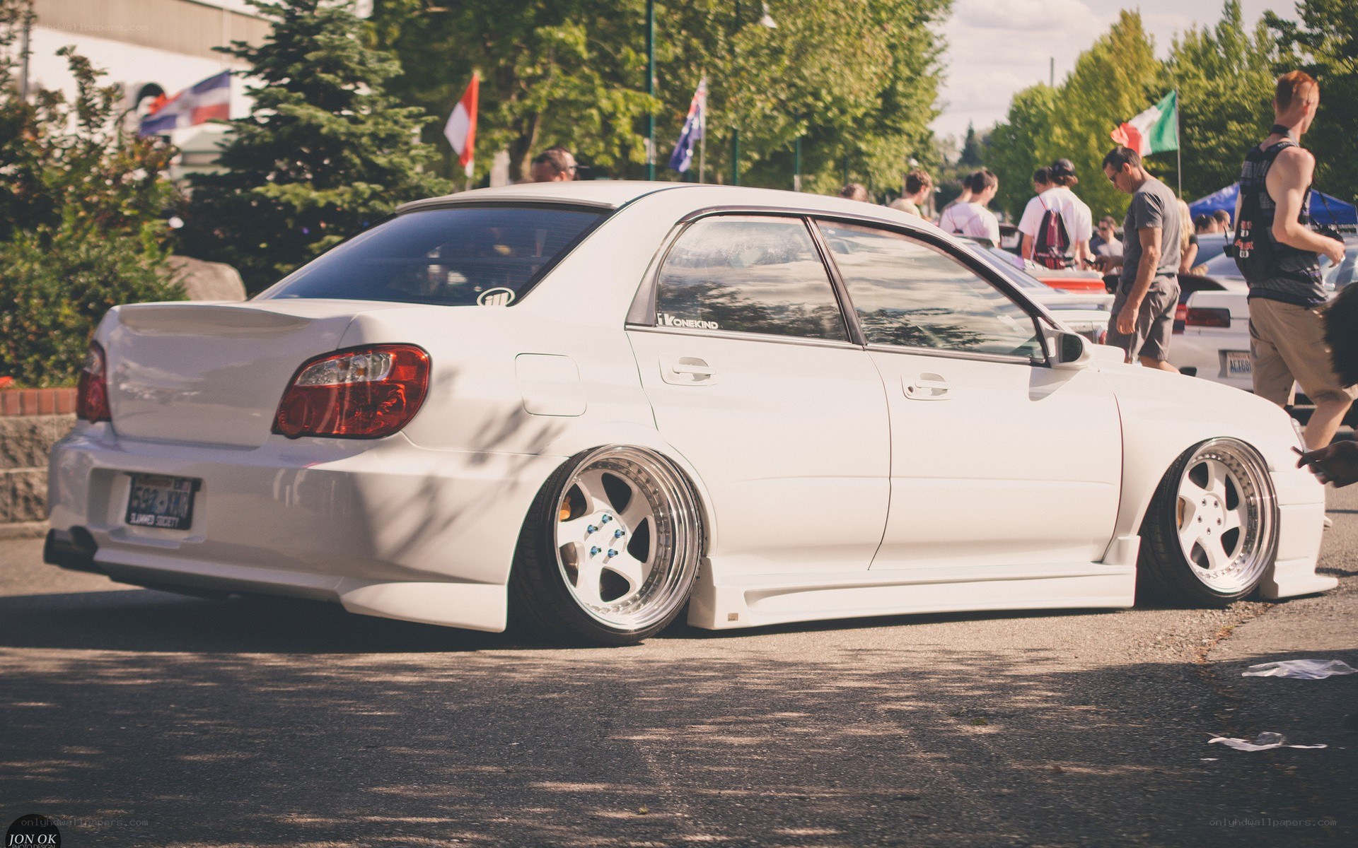 White modified sedan at car show