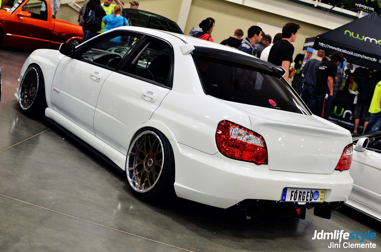 White modified sedan at car show
