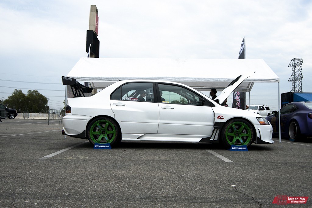 White modified sedan at car show