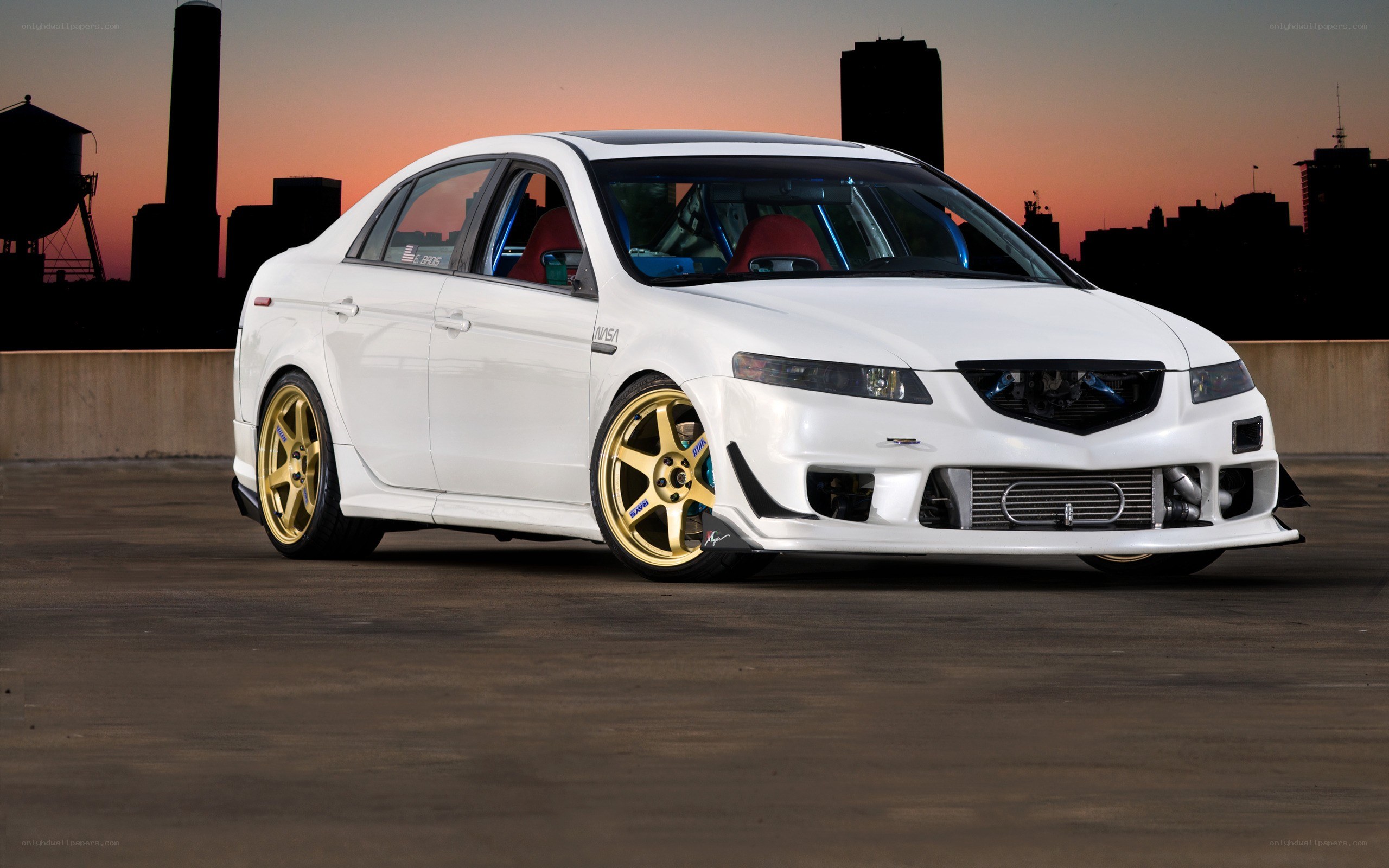 white modified sedan at sunset