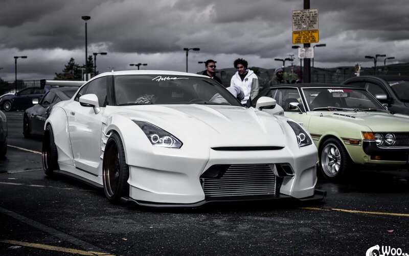 White modified sports car at a meet