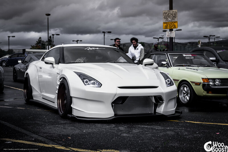 white modified sports car at a show