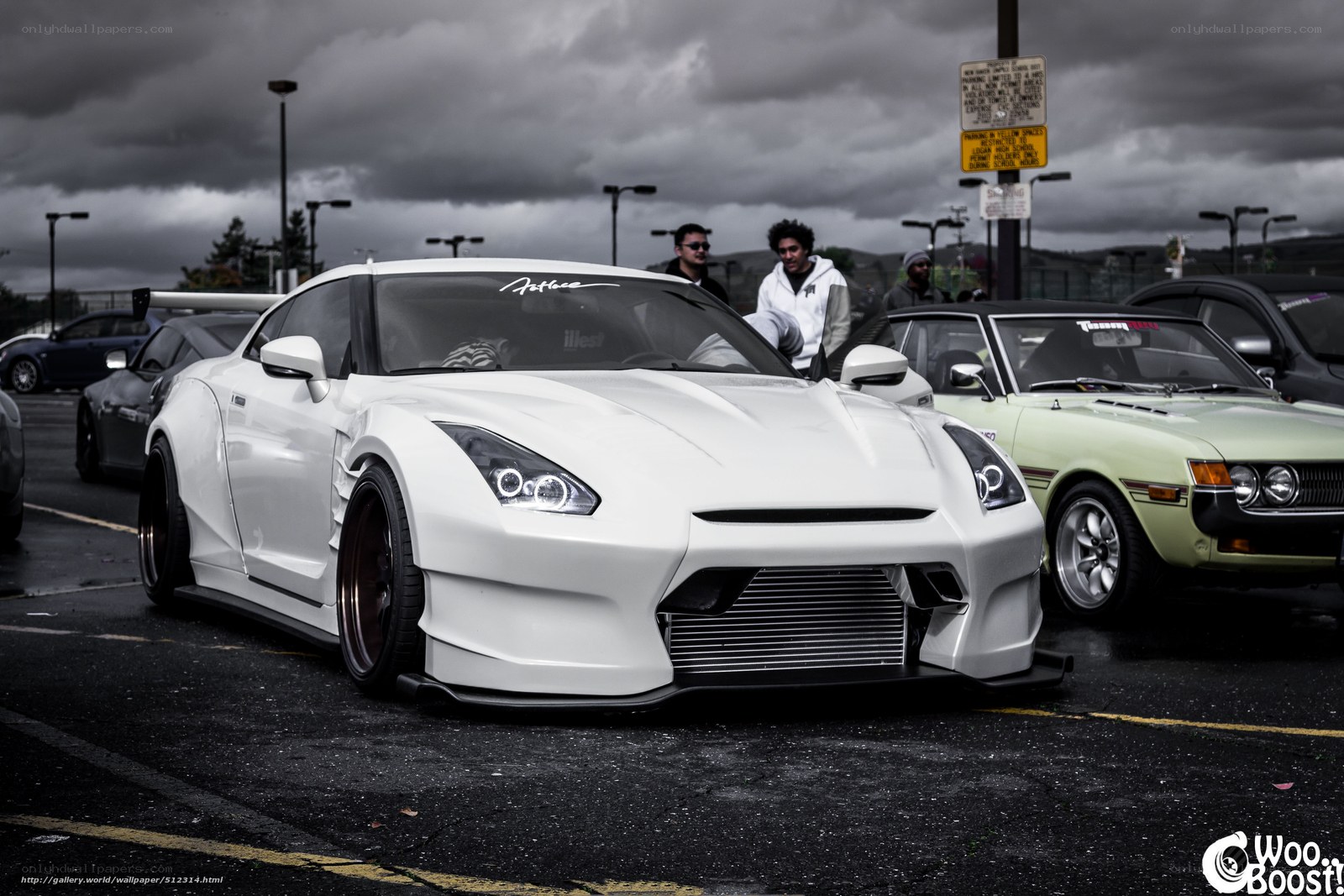 white modified sports car at a show