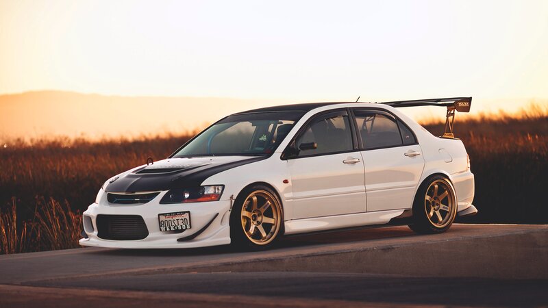white modified sports car at sunset