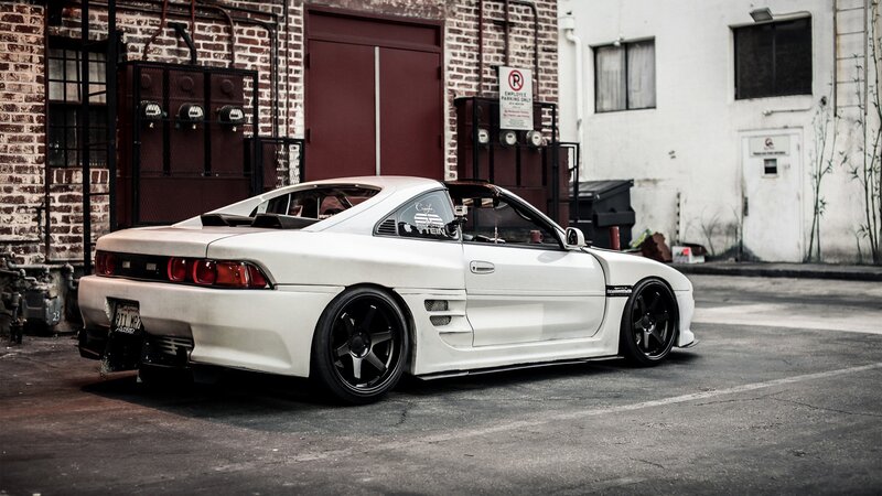White Modified Sports Car — Urban, Afternoon, Photograph, Brick Building