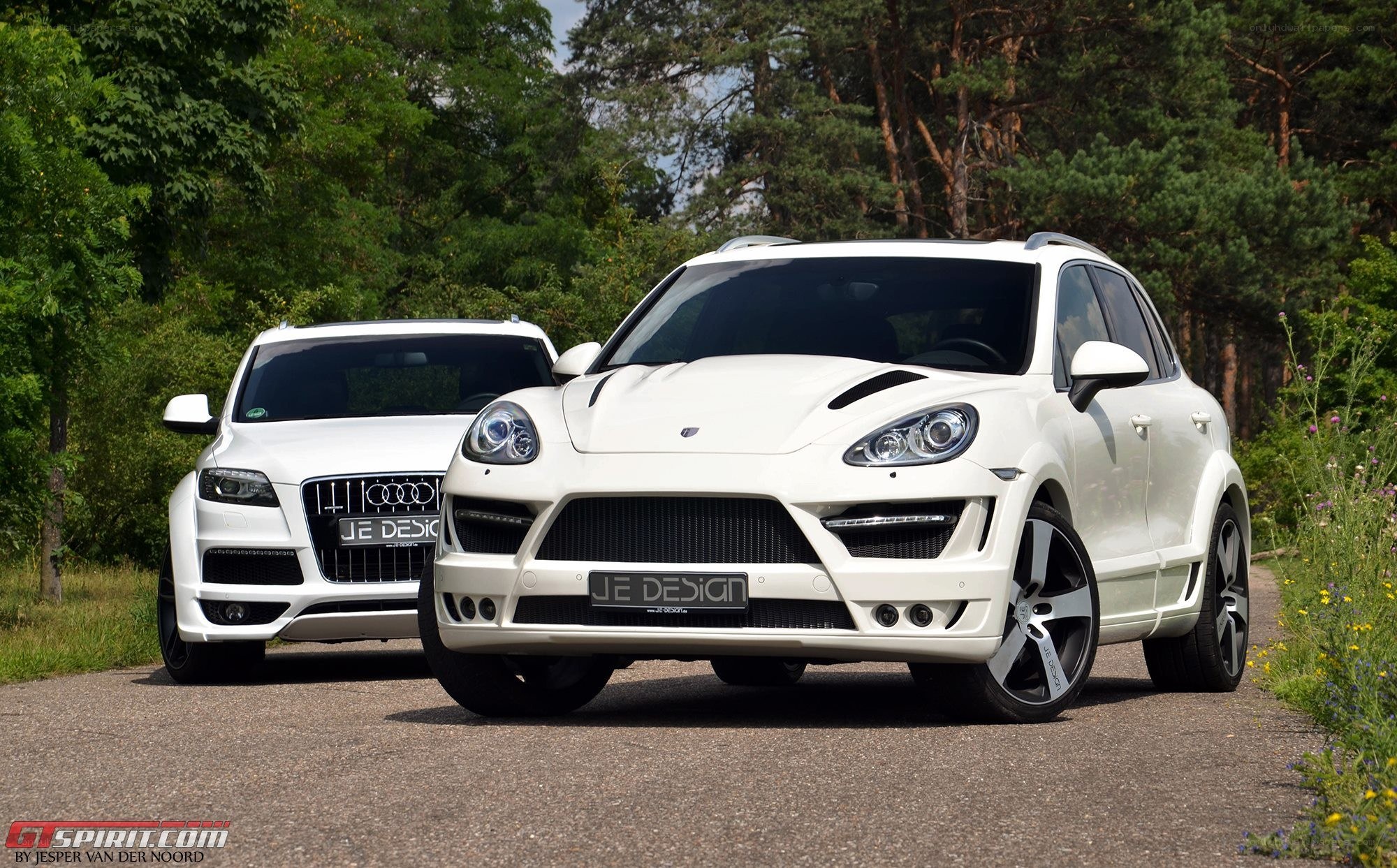 White modified SUVs on a road