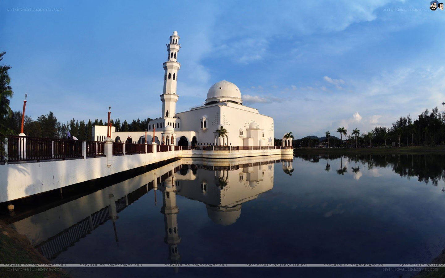 White mosque reflected in water