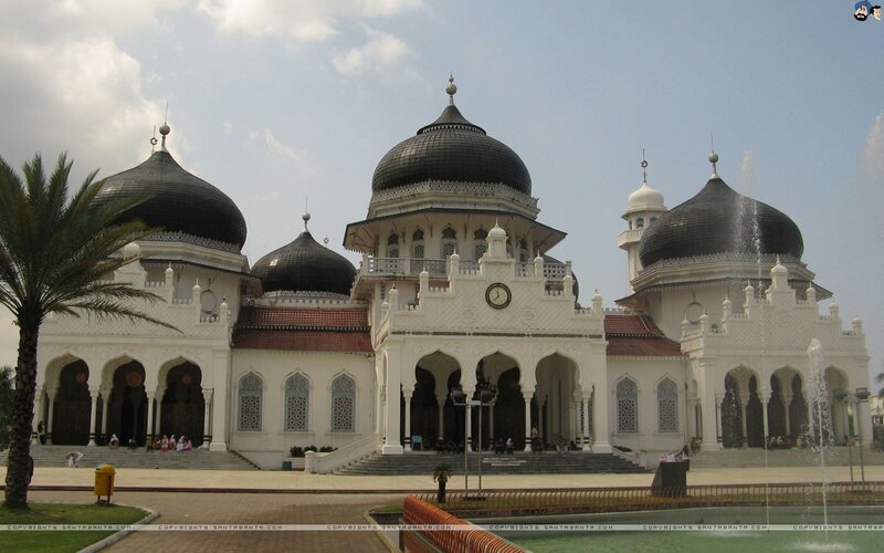 White mosque with black domes