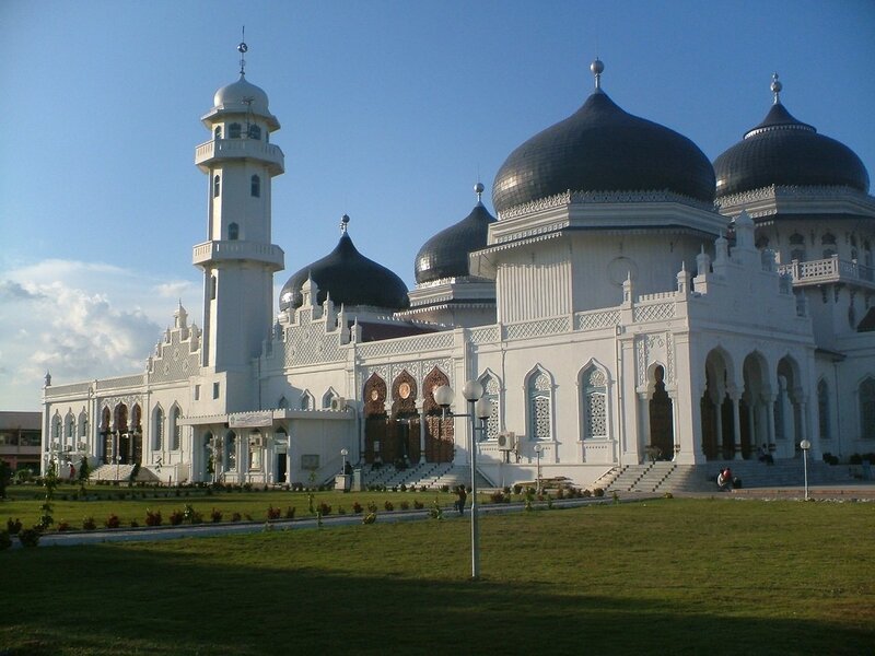 White mosque with black domes