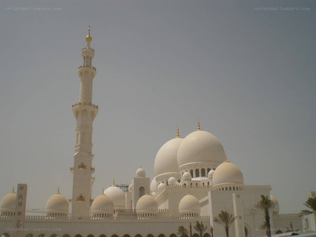 white mosque with domes and minaret