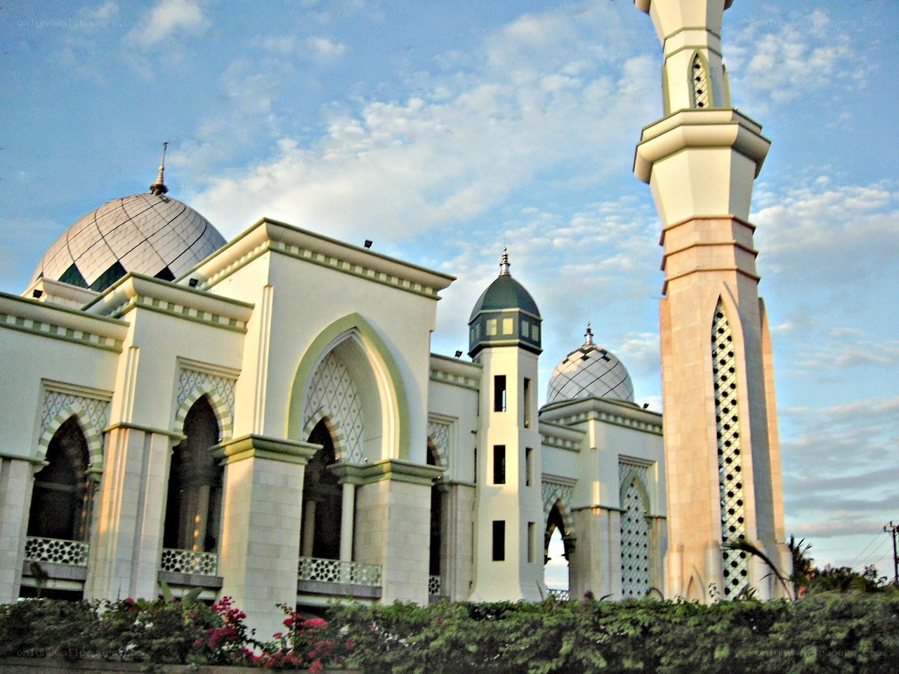 White mosque with domes and minaret