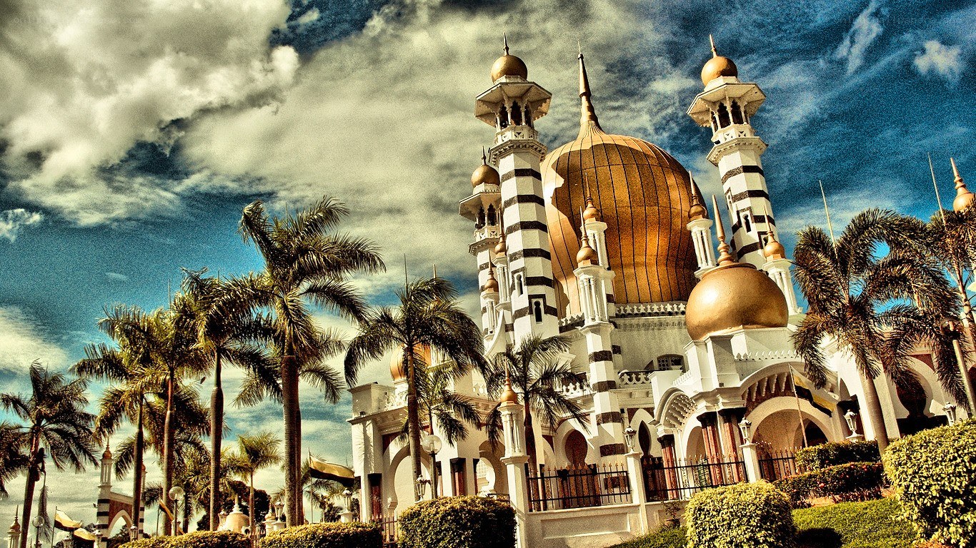 White mosque with golden domes