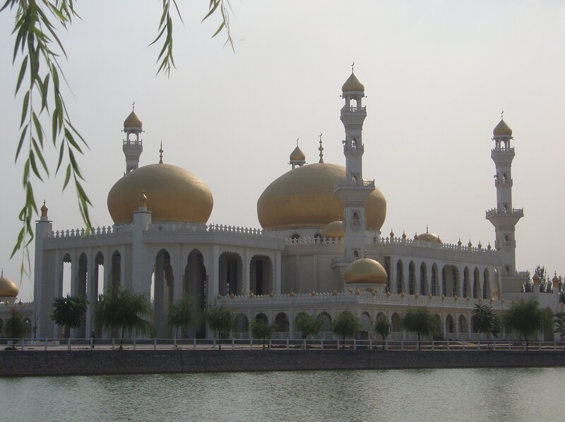 White mosque with golden domes