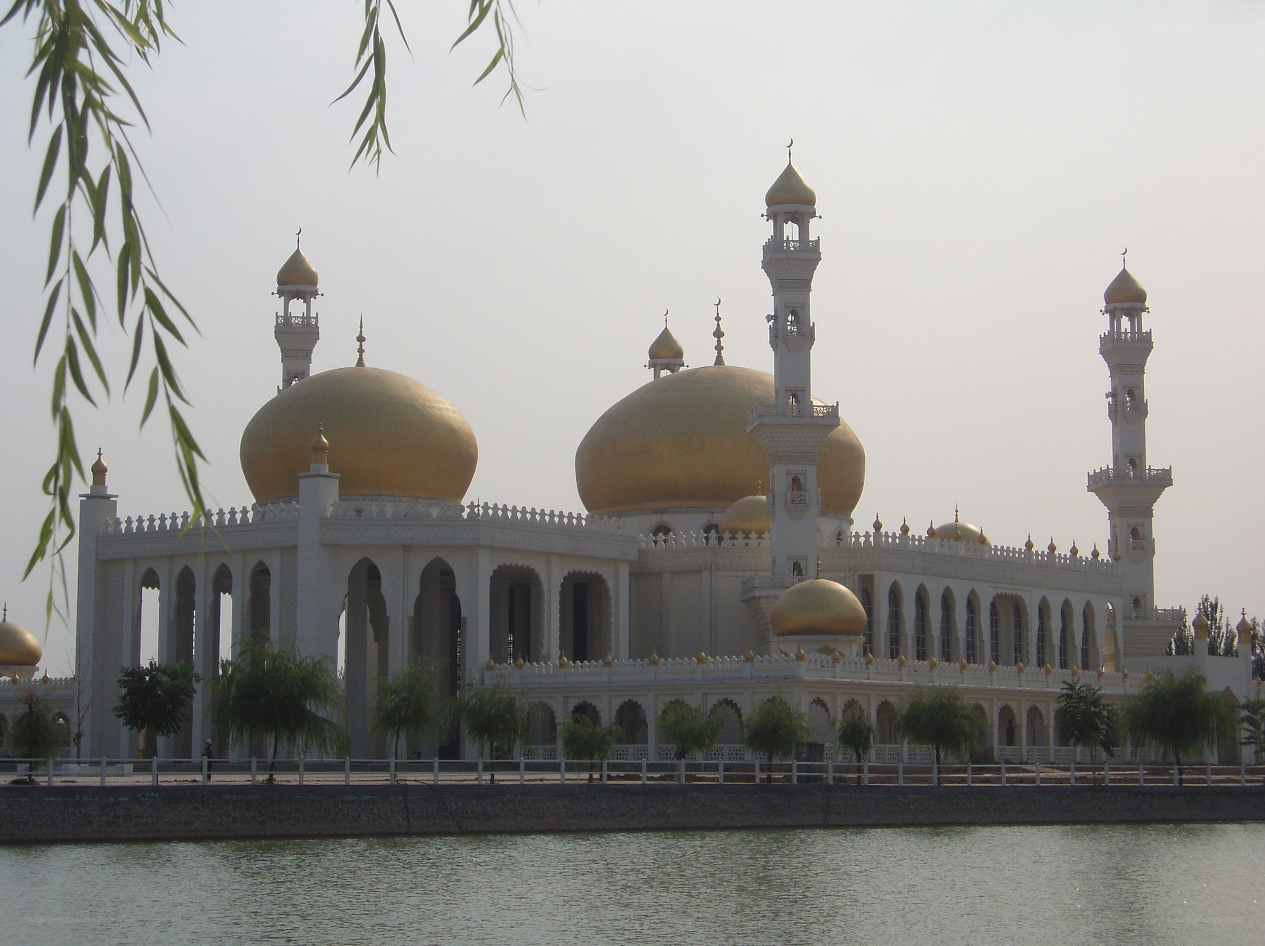White mosque with golden domes