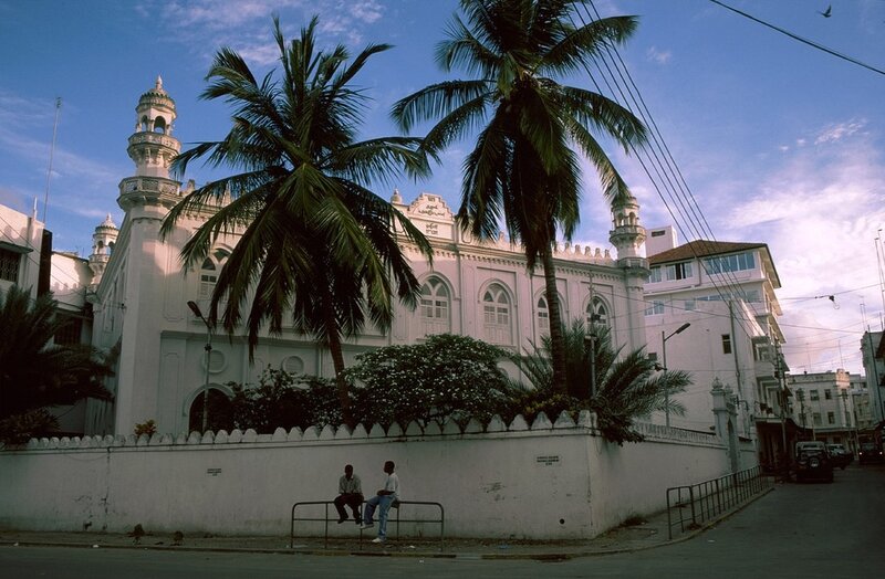 White mosque with palm trees