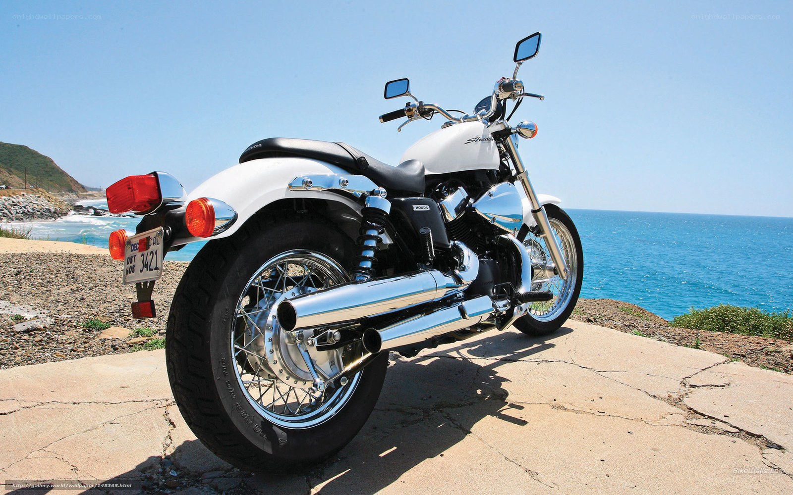 White motorcycle by the ocean