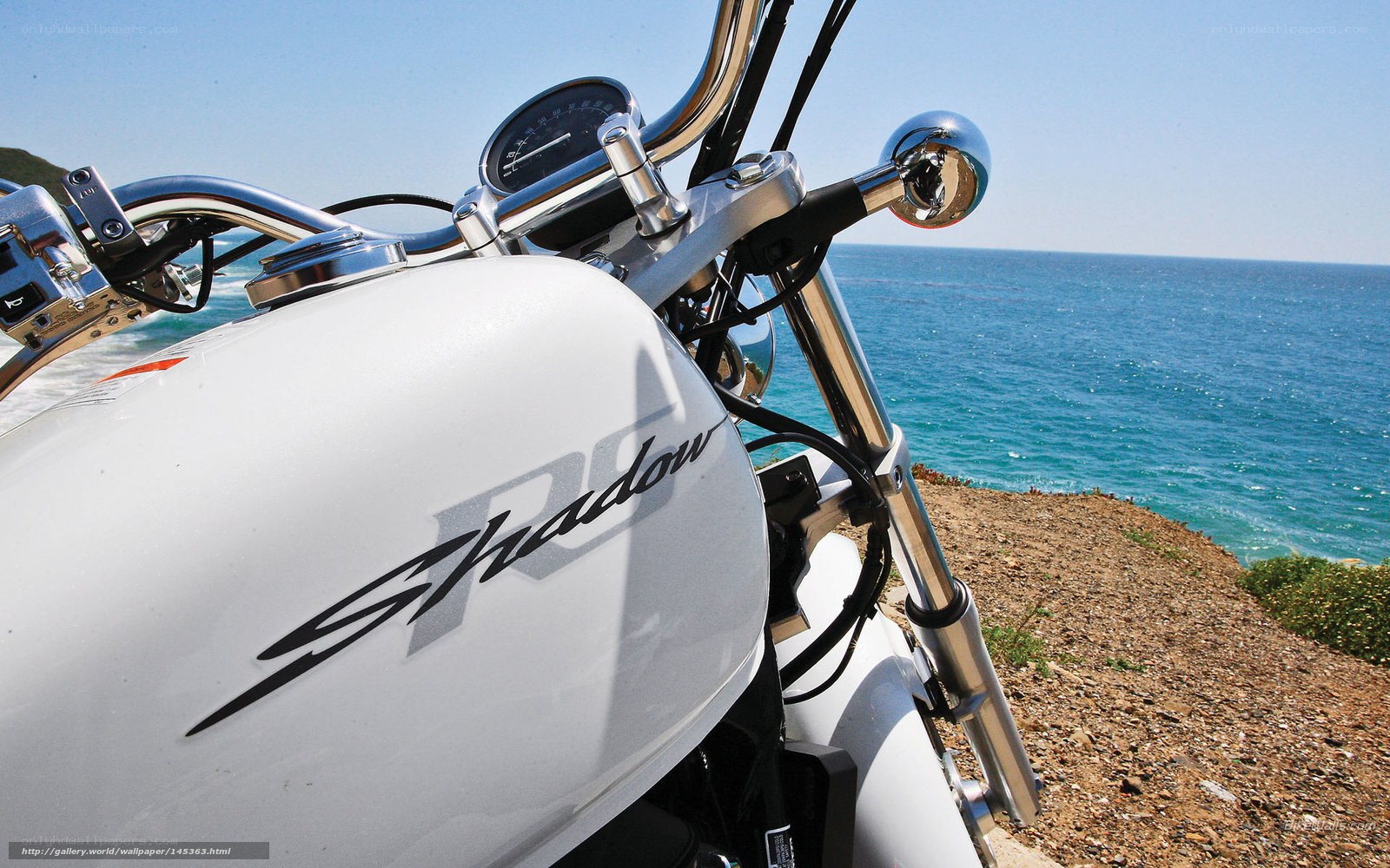 White motorcycle by the sea