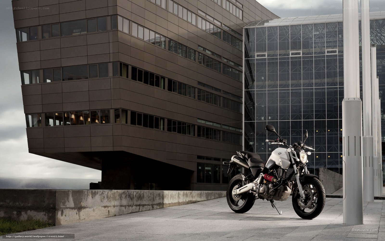 White motorcycle in front of modern building