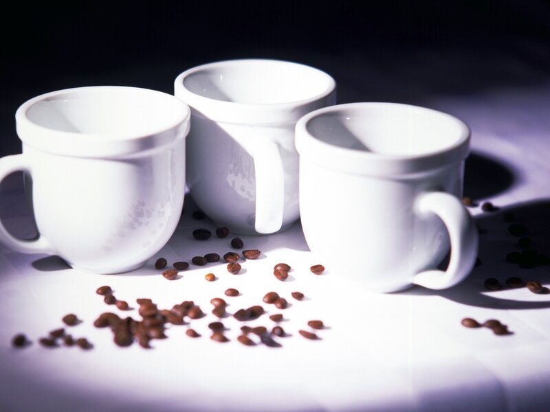 White mugs with coffee beans