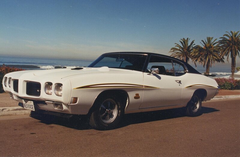 White muscle car by the ocean