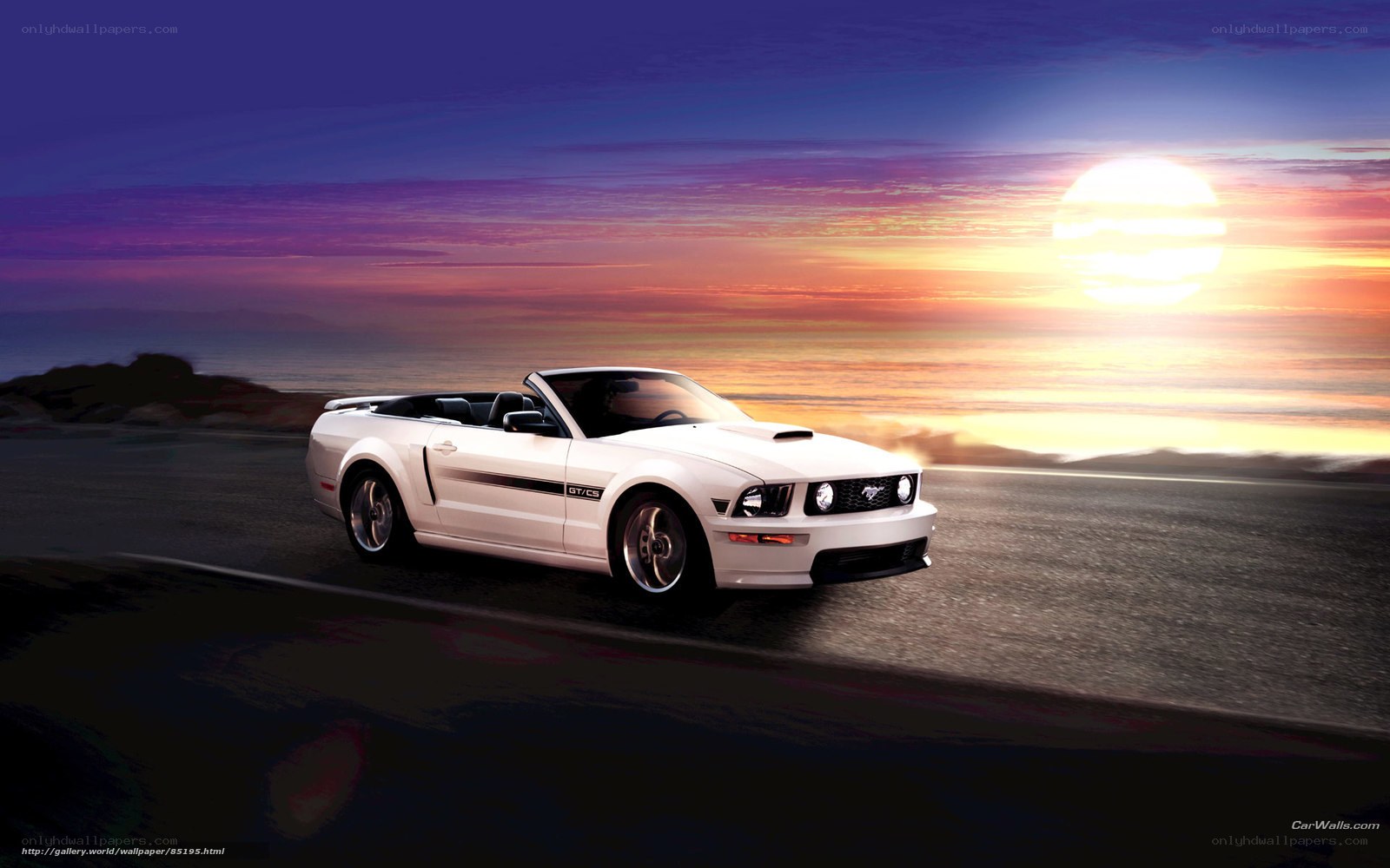 White Mustang convertible at sunset