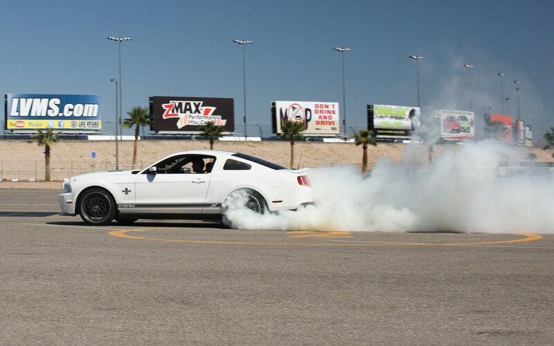 white mustang doing burnout