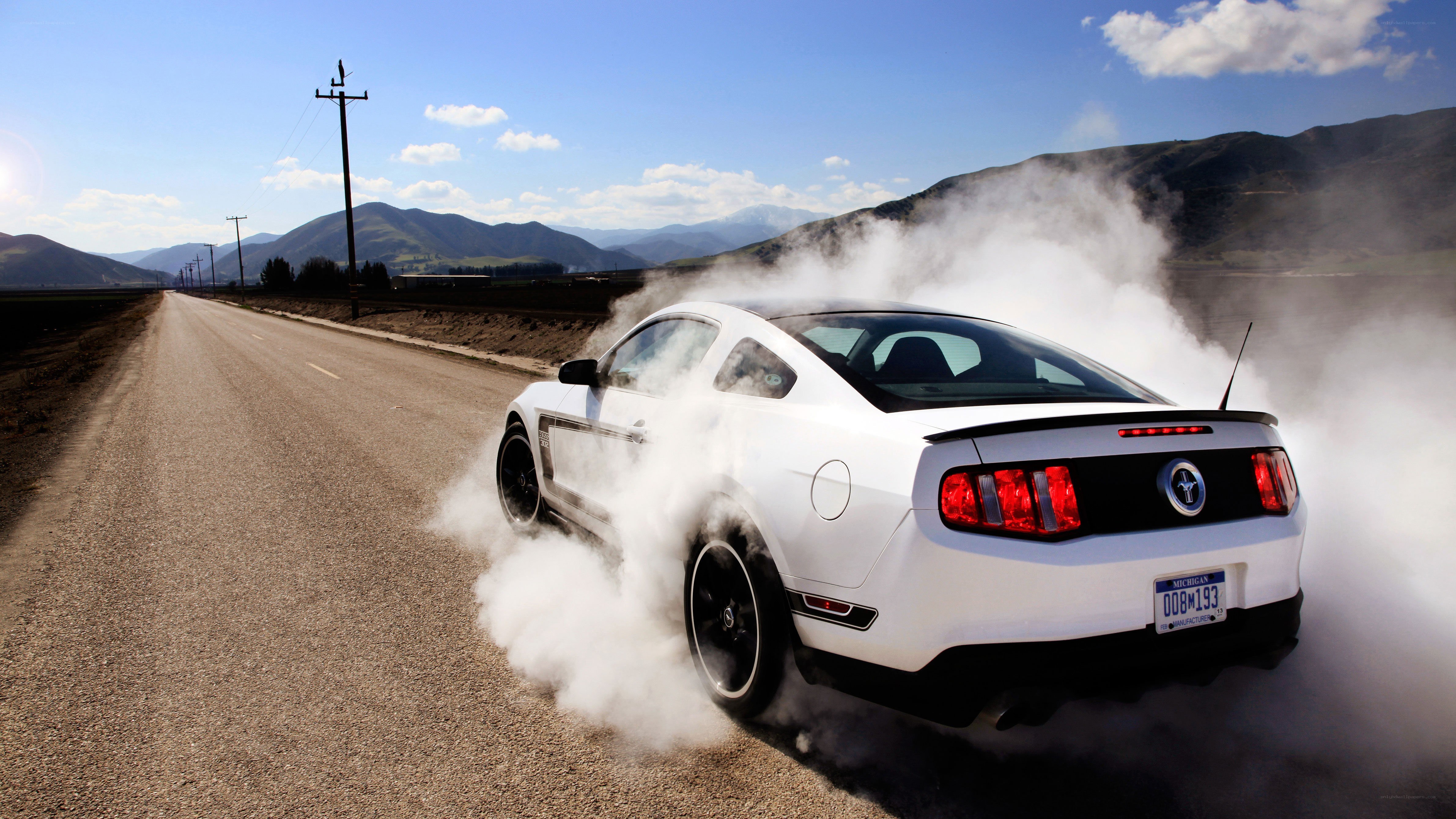 white mustang doing burnout