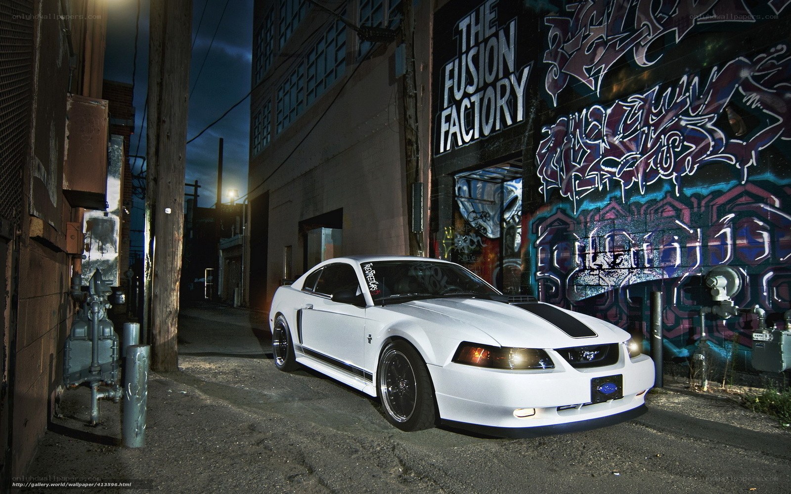 white mustang in alley at night