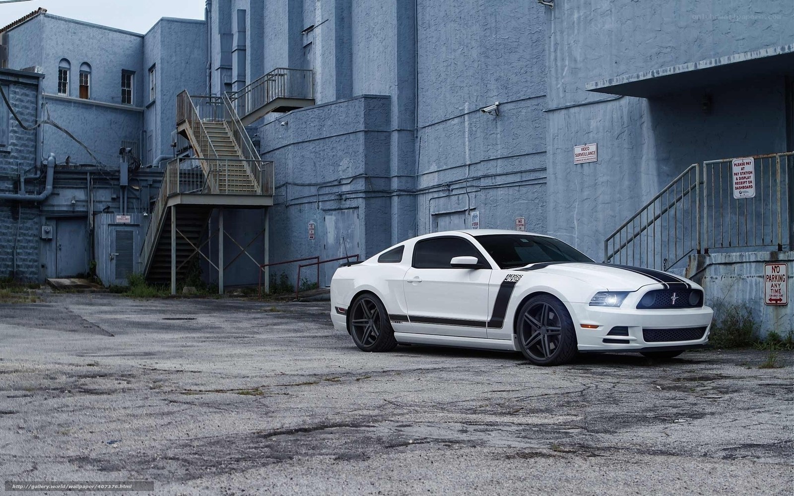 white mustang in industrial lot