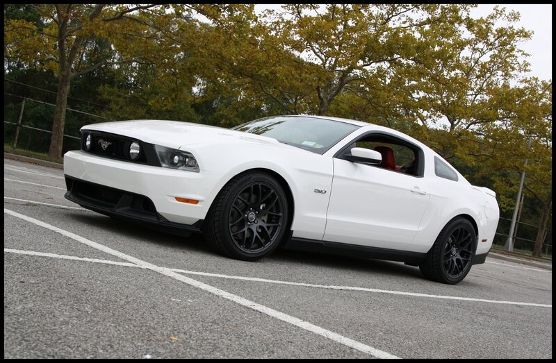 white mustang in parking lot