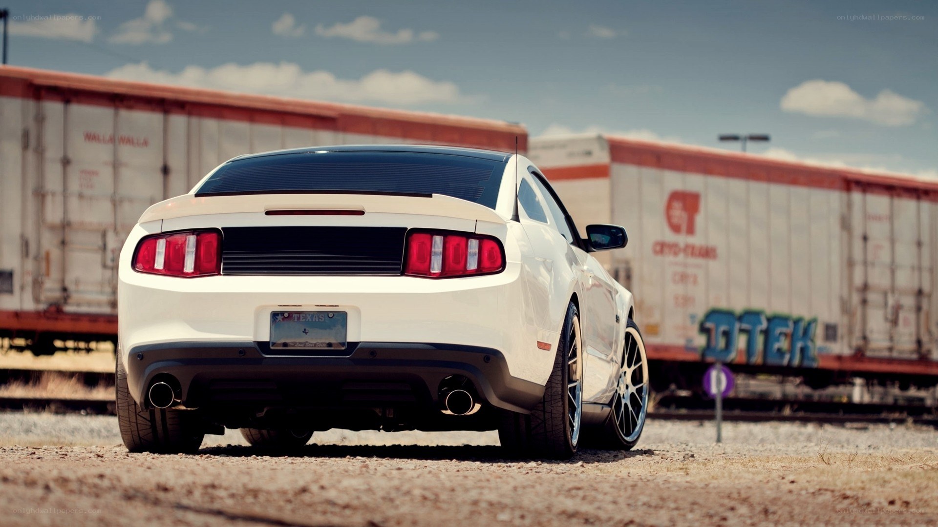 white mustang near train