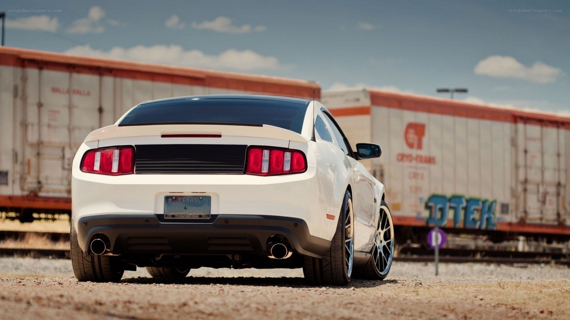 white mustang near train