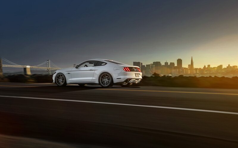 White Mustang on city road