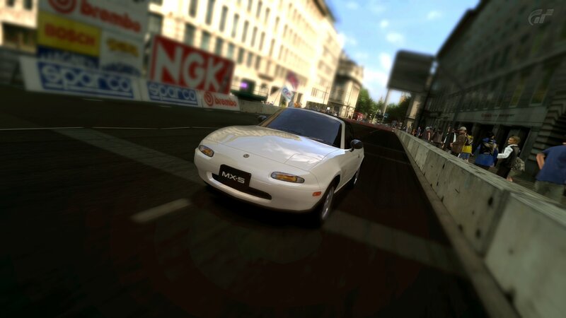 White MX-5 racing on city street