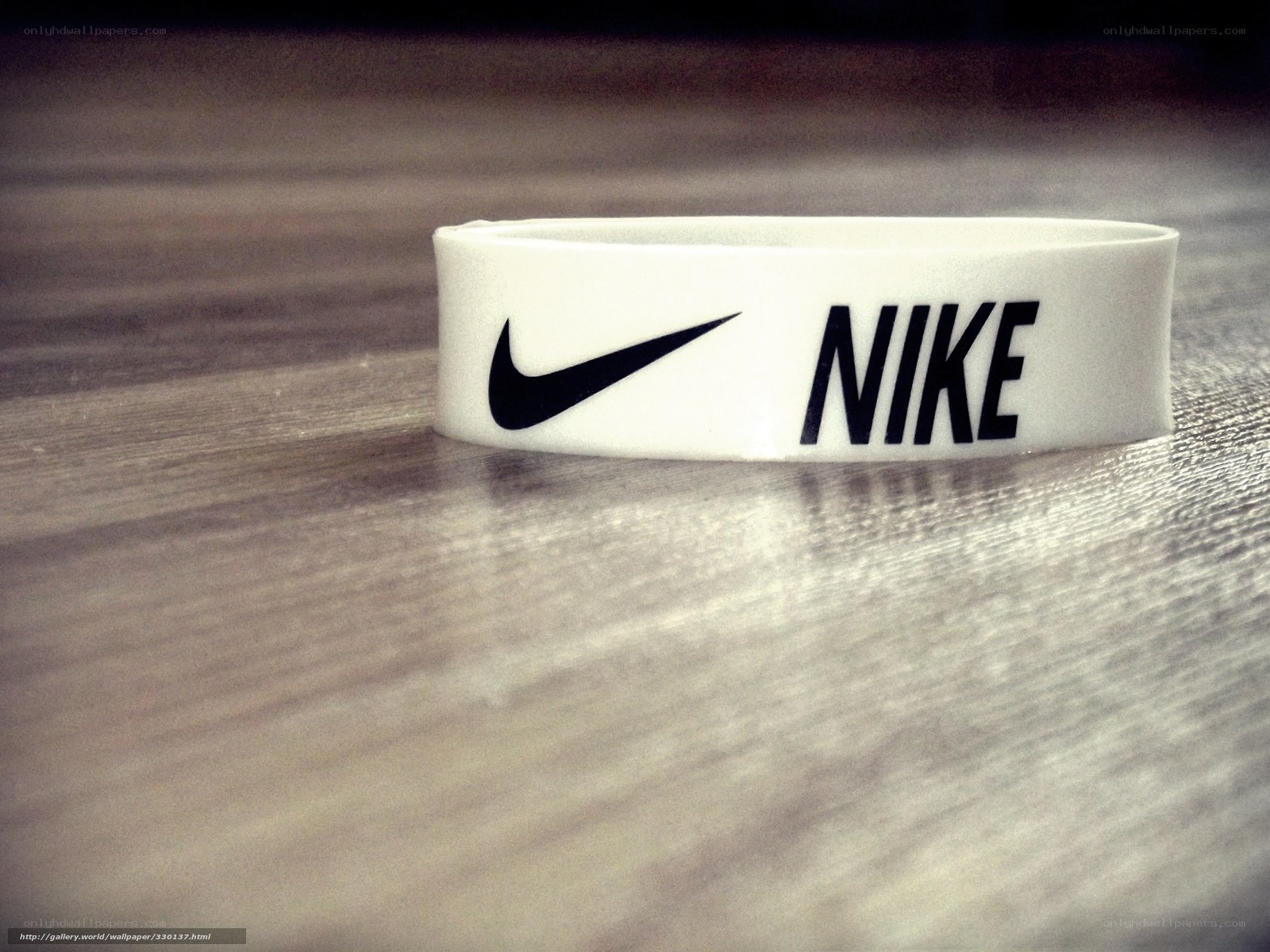 white nike wristband on wood