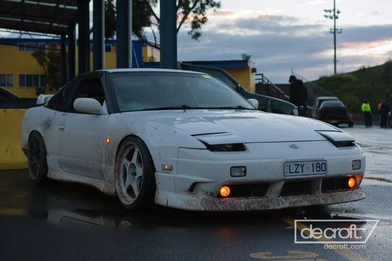 white nissan 180sx on wet track