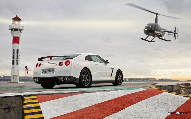 White Nissan GT-R near lighthouse