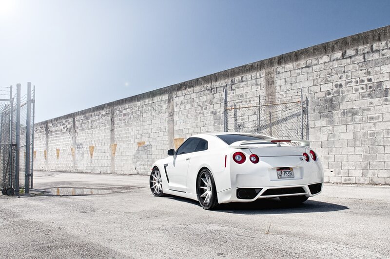 White Nissan GT-R parked by wall