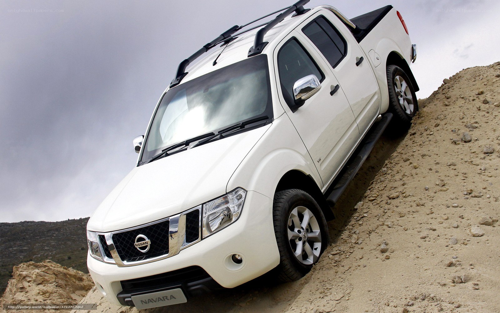 White Nissan Navara on a dirt hill