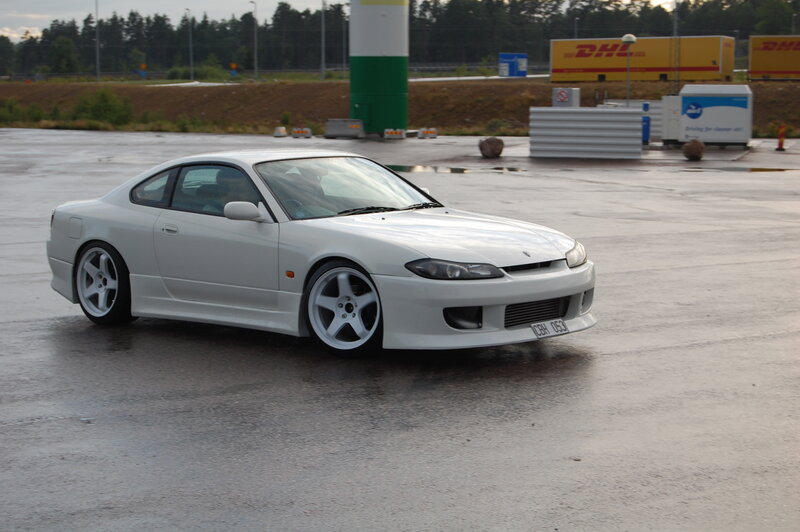 White Nissan S15 on wet pavement